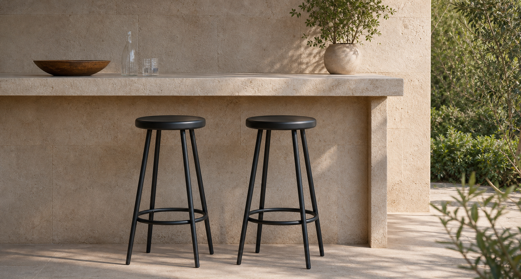 Outdoor stools beside a stone counter